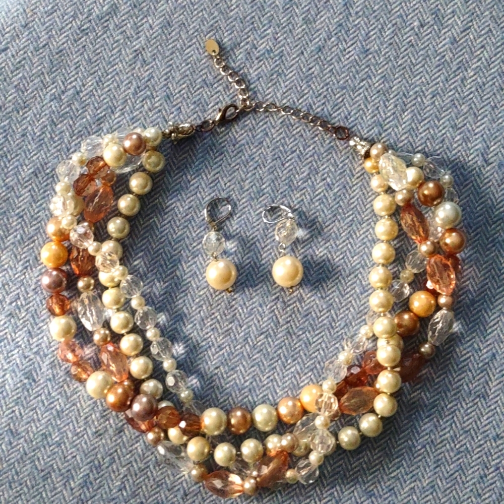 Multi strand Necklace With earrings. Colors include Pearl, clear, brown and tan.